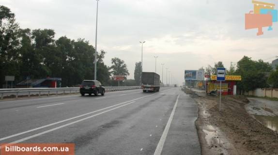 Billboard A in With. Mila, 6х3  s. Mila, trasa M-06 "Kiiv-Cop" (Zitomir), km 25+780 pravo, bila avtobusnoi zupinki, za 400m do magazinu "Fora", cerez 150m pisla povorotu na Dmitrivku Photo 1