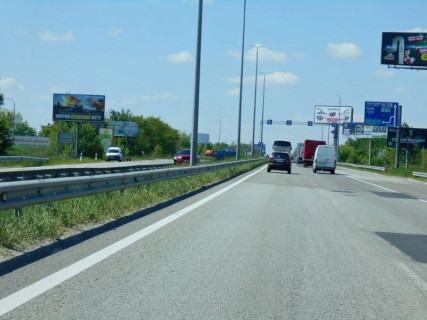 Billboard B in With. Mila, 6х3  с. Мила, траса М-06 "Київ-Чоп" (Житомир), км 26+800 ліво, біля садового центру, через 550м після магазину "Фора", за 625м до АЗС GLUSCO Photo 1